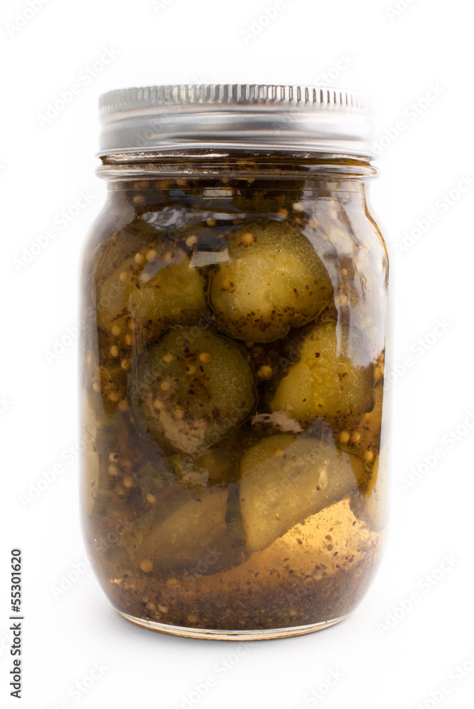 A jar of pickles in a mason jar on a white isolated background A jar of pickles in a mason jar on a white isolated background