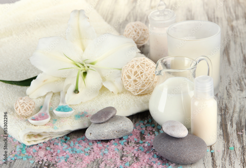 Beautiful spa setting with lily on wooden table close-up Beautiful spa setting with lily on wooden table close-up