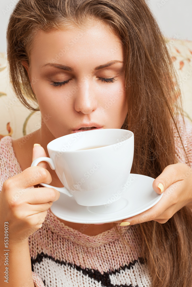 girl with closed eyes takes a sip of tea girl with closed eyes takes a sip of tea