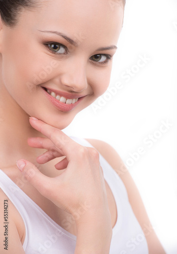 Sunny smile. Beautiful young woman looking at camera and holding