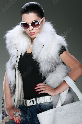 photo beautiful girl is in fashion style is in fur clothes