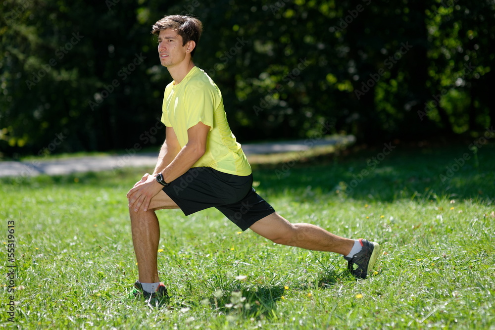 Athlete at the park warming and stretching