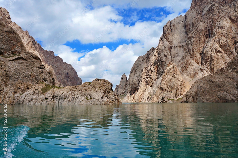 Fine Kelsu mountain lake with grandiose rocks and the dark blue