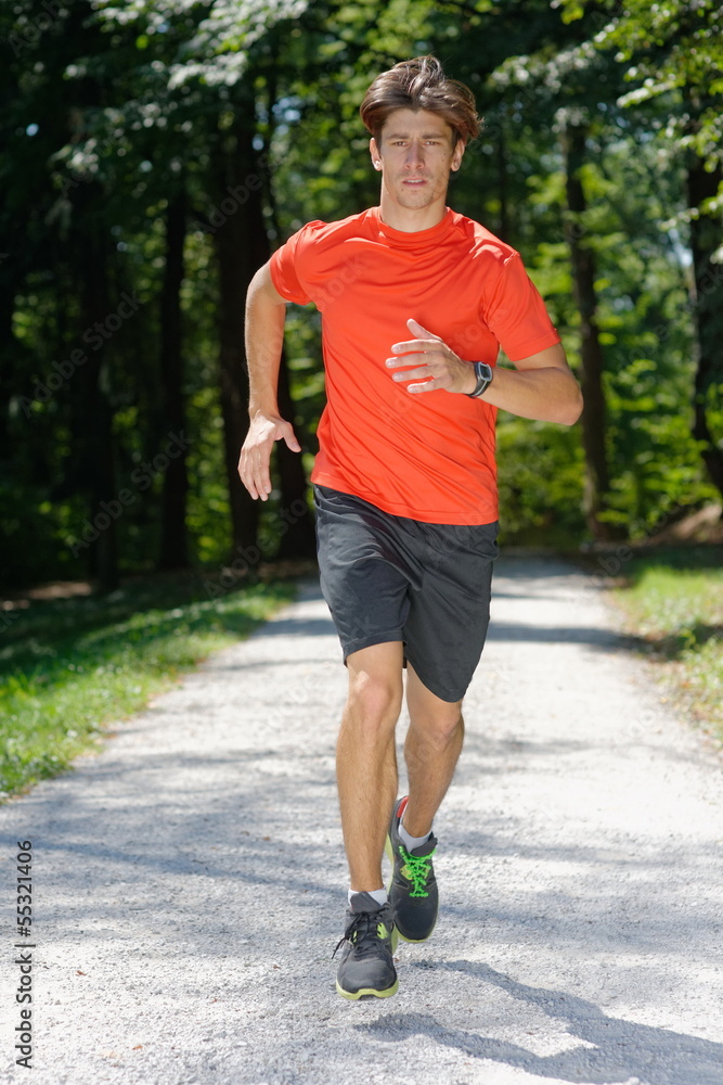 Young man / athlete Running Through Park