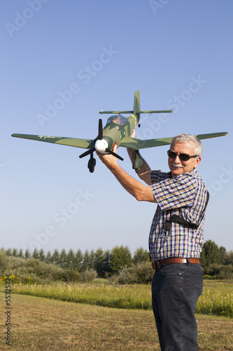 Friendly senior RC modeller showing his new plane model