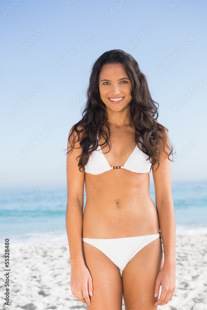 Smiling pretty brunette posing in white bikini Smiling pretty brunette posing in white bikini