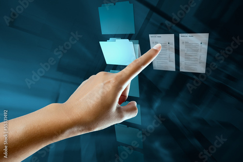 a woman hand select and open a folder on a digital screen photo