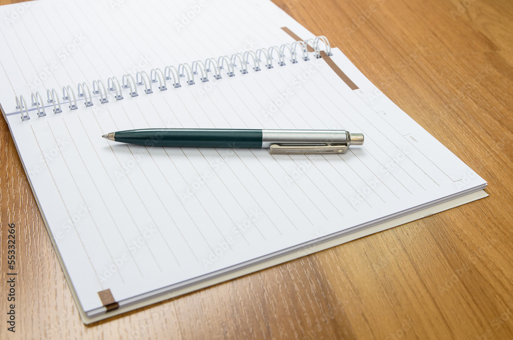Classic pen and notebook on wooden desk Classic pen and notebook on wooden desk