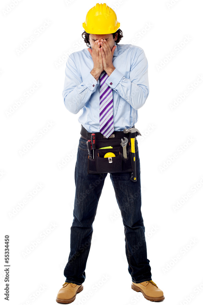 Male architect in a hard hat with toolkit Male architect in a hard hat with toolkit