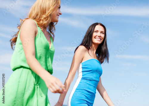 girls walking on the beach