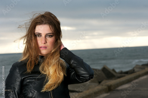 Beautiful girl with wind blowing hair outdoors © mimagephotos