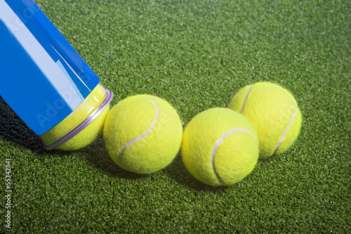 Tennis concept: tennis balls out of a container