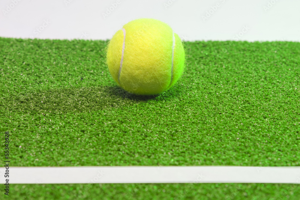 Tennis concept. Ball, line and green grass tennis court.horizo