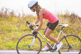 Portrait of a single female athlete on bike exercising
