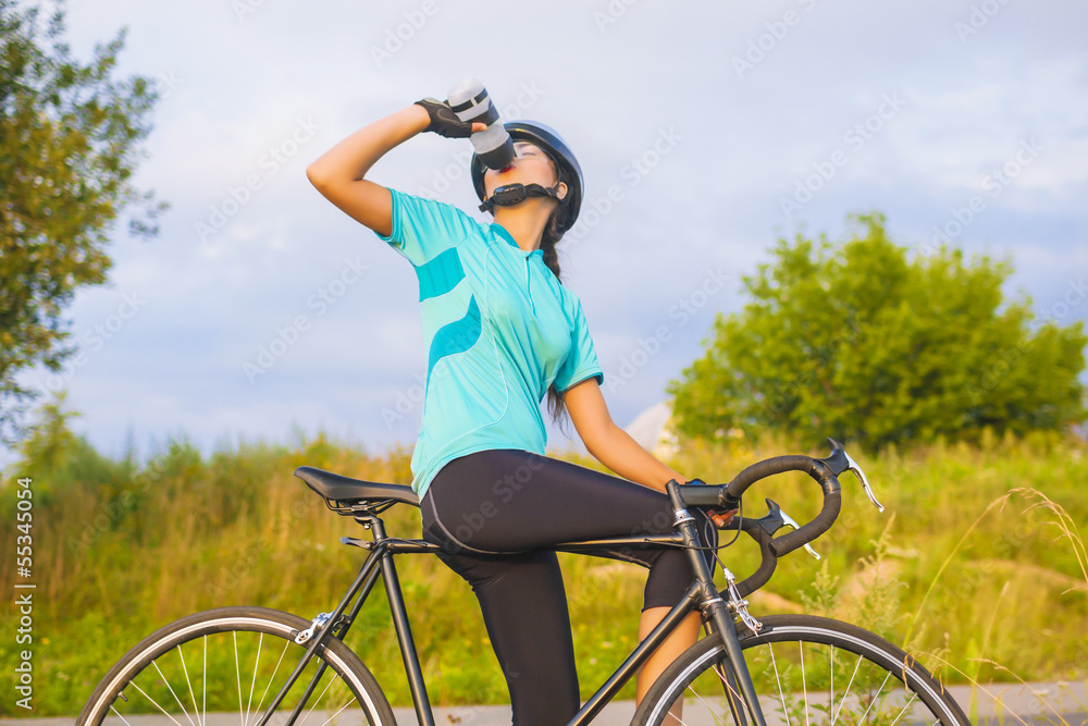 Nice Portrait of young female cyclist athlete having a break.