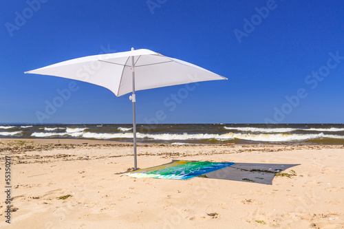 Fototapeta Naklejka Na Ścianę i Meble -  White parasol on the beach of Baltic Sea in Sobieszewo