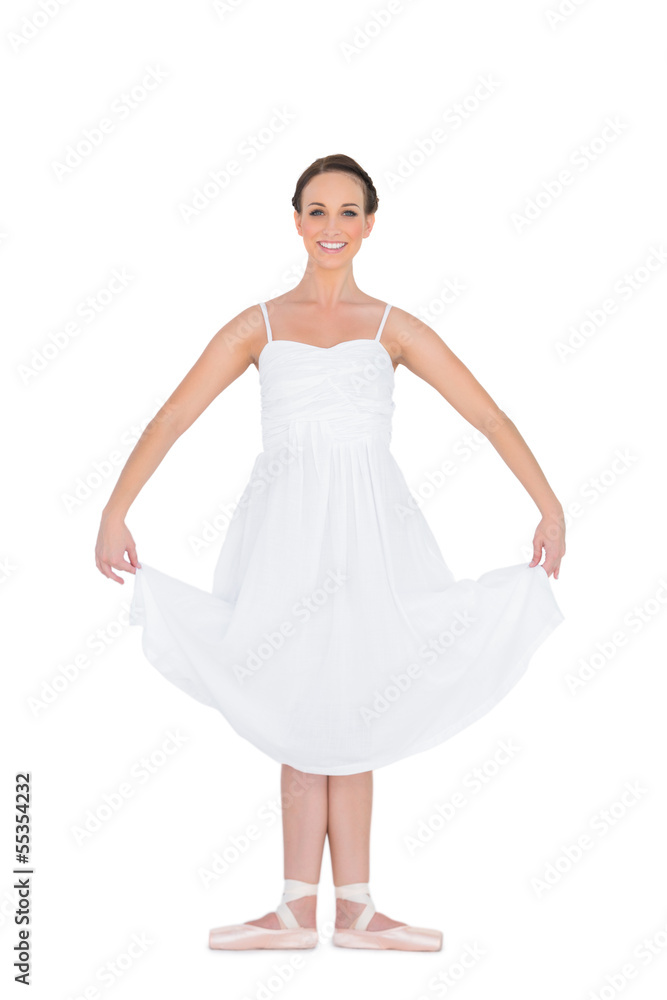 Cheerful young ballet dancer standing in a pose Cheerful young ballet dancer standing in a pose