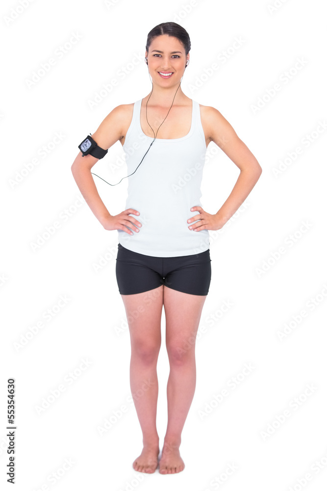 Cheerful slender model wearing armband holding mp3 player Cheerful slender model wearing armband holding mp3 player