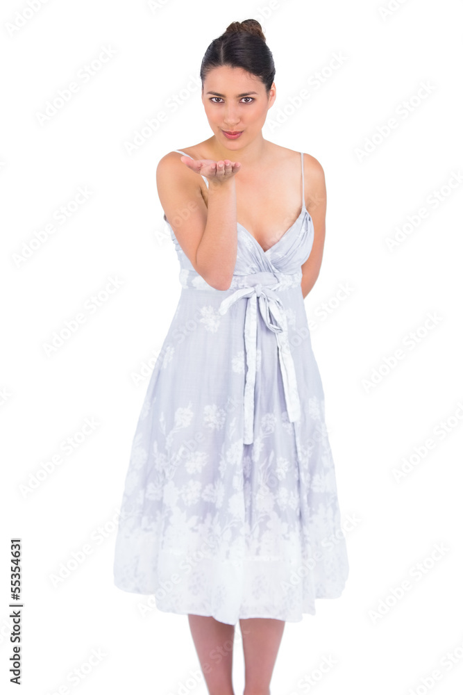 Seductive young model in summer dress kissing at camera