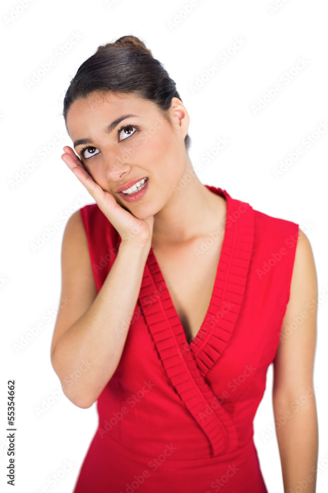 Sexy tied haired brunette in red dress thinking Sexy tied haired brunette in red dress thinking