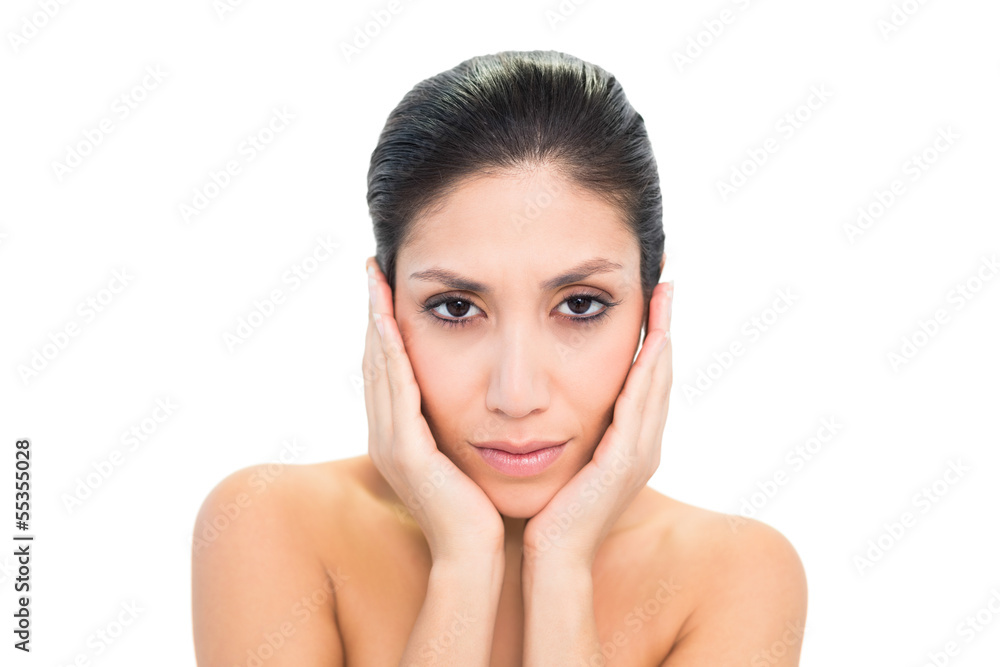 Peaceful brunette touching her face with both hands Peaceful brunette touching her face with both hands