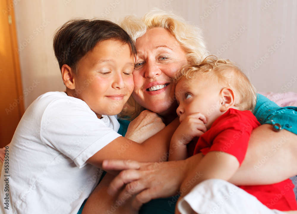 Happy grandmother hugging with her grandsons