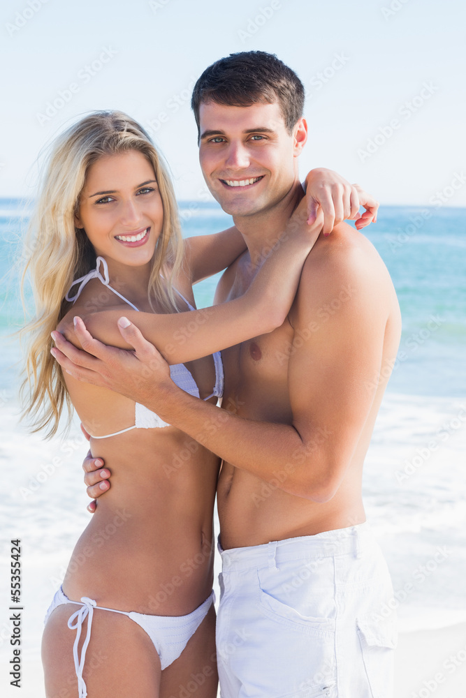 Attractive couple hugging and smiling at camera Attractive couple hugging and smiling at camera