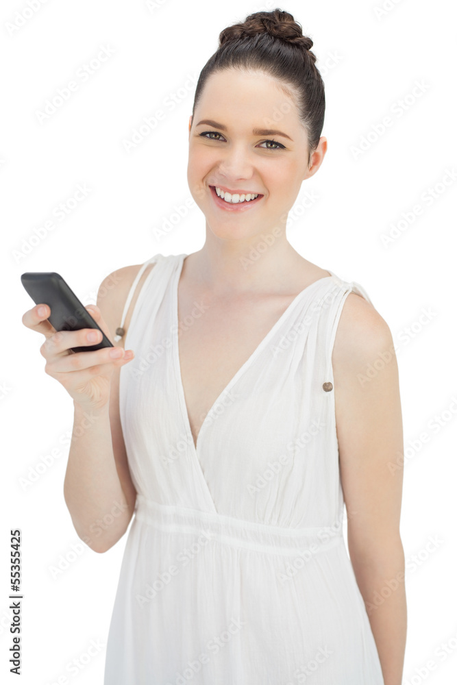 Cheerful pretty model in white dress sending text message Cheerful pretty model in white dress sending text message