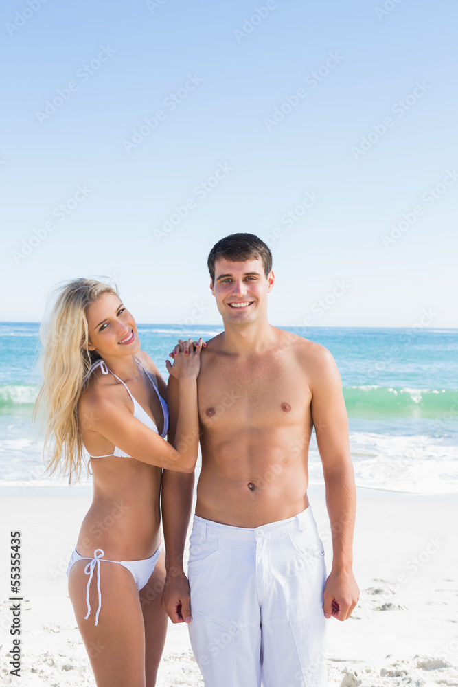 Beautiful young couple smiling at camera Beautiful young couple smiling at camera