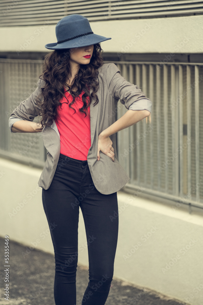 Attractive glamorous brunette wearing stylish clothes posing