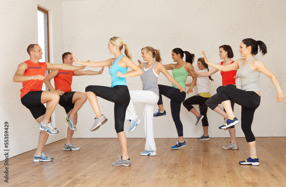 Naklejka premium Group Of People Exercising In Dance Studio