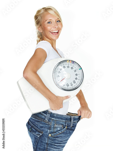 Beautiful girl with scale is proud to lose weight photo