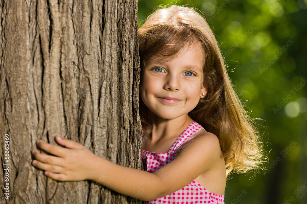 Little girl near a tree Little girl near a tree
