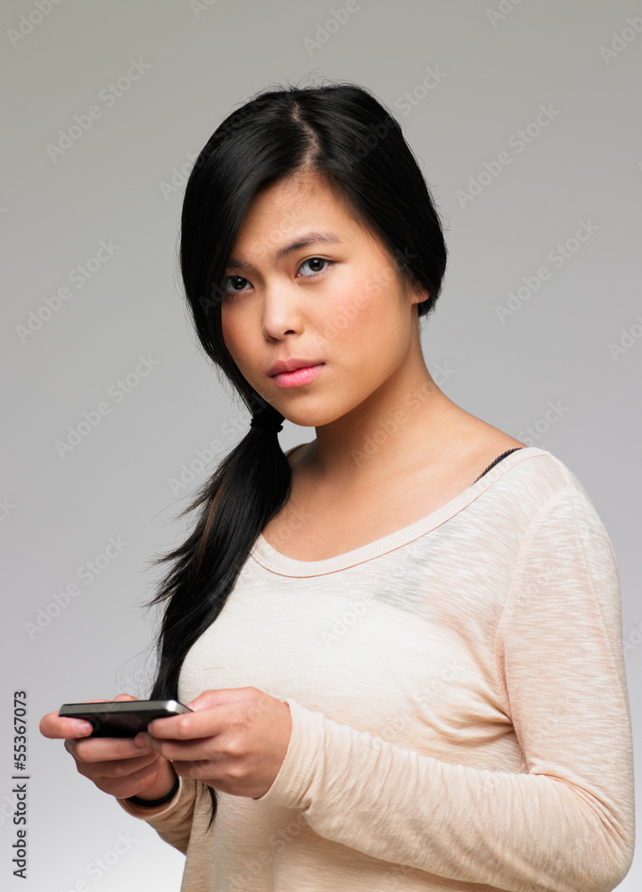 Teenage Girl Being Bullied By Text Message On Mobile Phone Teenage Girl Being Bullied By Text Message On Mobile Phone