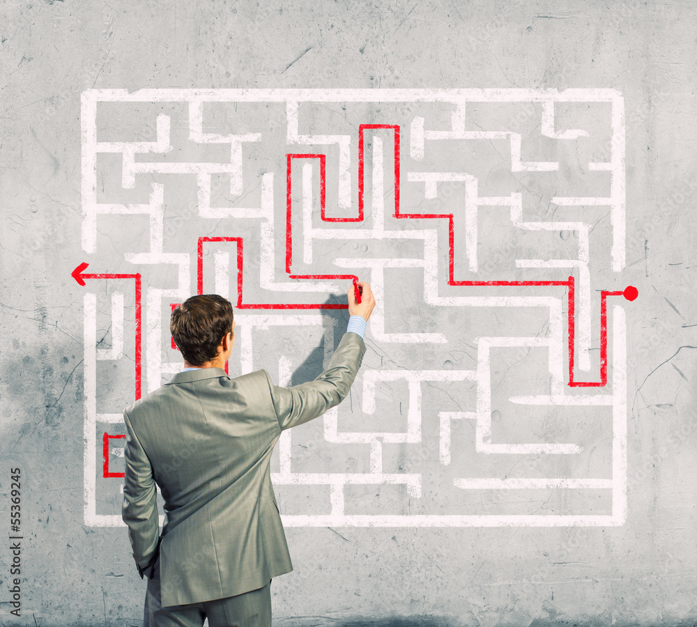 Businessman solving labyrinth problem Businessman solving labyrinth problem