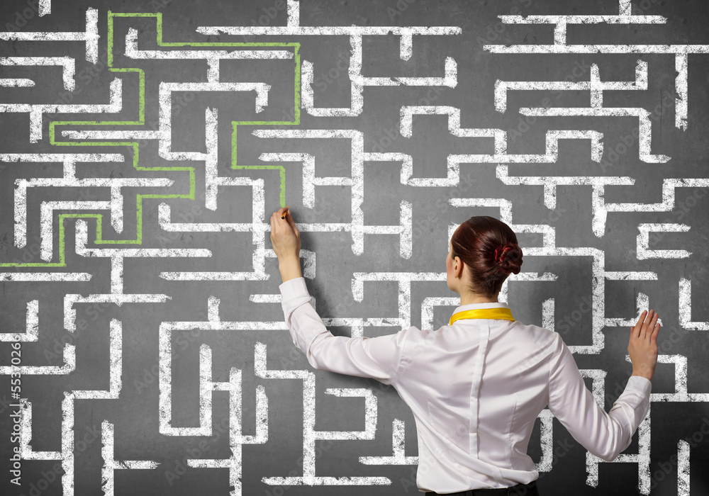 Businesswoman solving maze problem Businesswoman solving maze problem