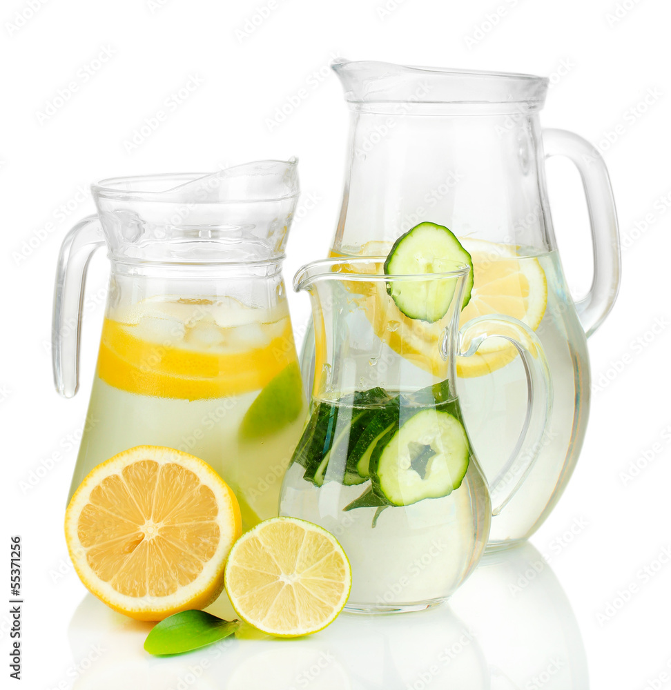 Cold water with lemon, cucumber and ice in pitchers isolated Cold water with lemon, cucumber and ice in pitchers isolated