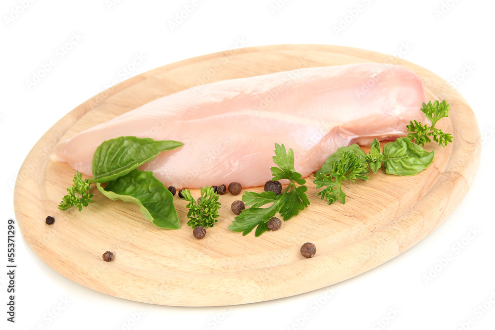 Raw chicken fillets on wooden board, isolated on white