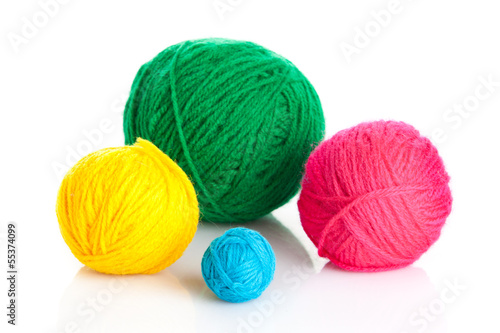 colorful different thread balls. wool knitting on white backgr