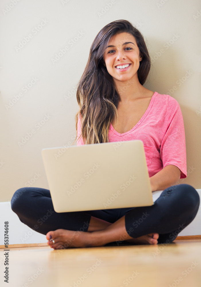 happy young woman using a laptop computer happy young woman using a laptop computer