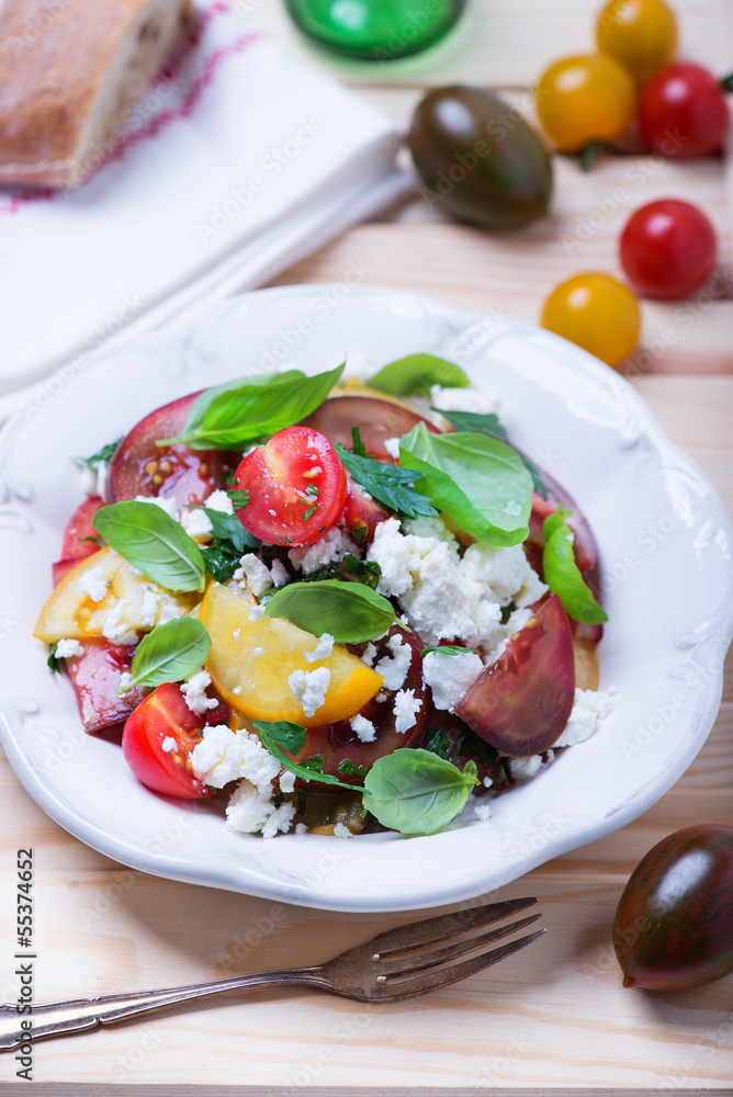 salad with red, yellow and black tomatoes and feta cheese salad with red, yellow and black tomatoes and feta cheese