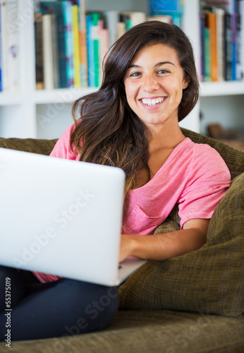 happy young woman using a laptop computer