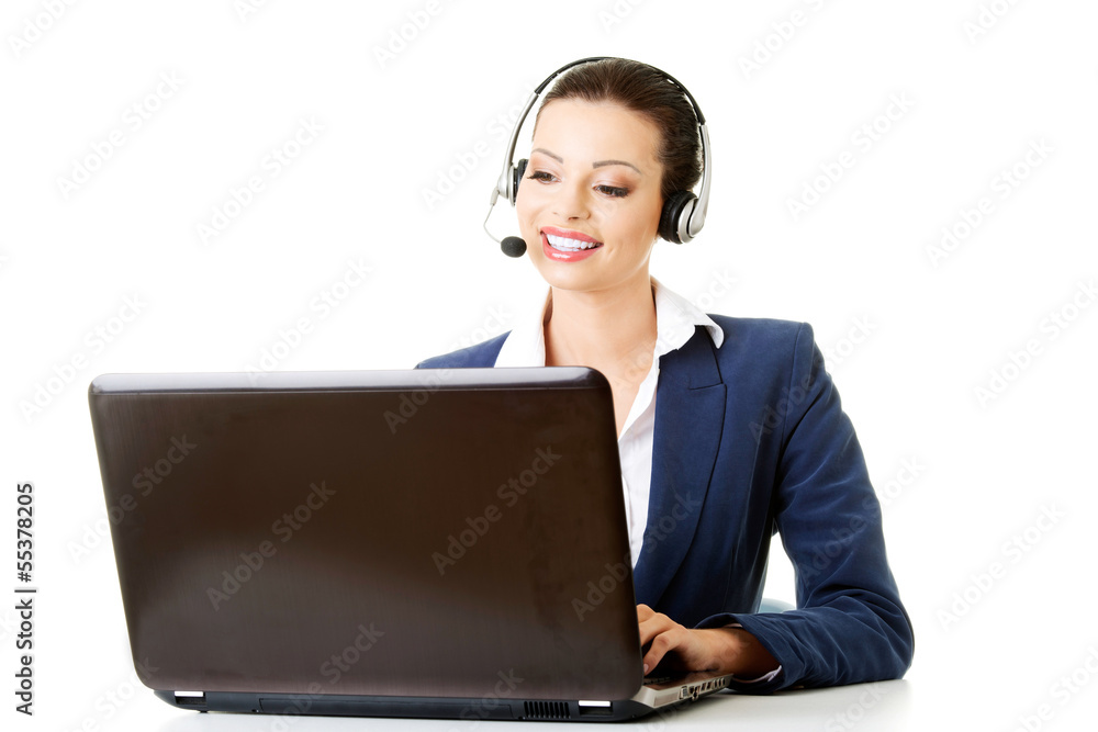 Beautiful young call-center assistant at the desk Beautiful young call-center assistant at the desk