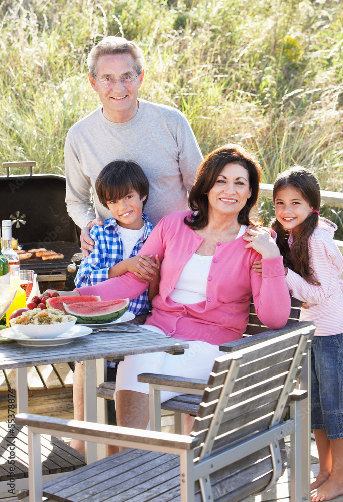 Grandparents And Grandchildren Having Outdoor Barbeque Grandparents And Grandchildren Having Outdoor Barbeque