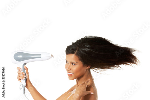 Woman with long hair holding blow dryer