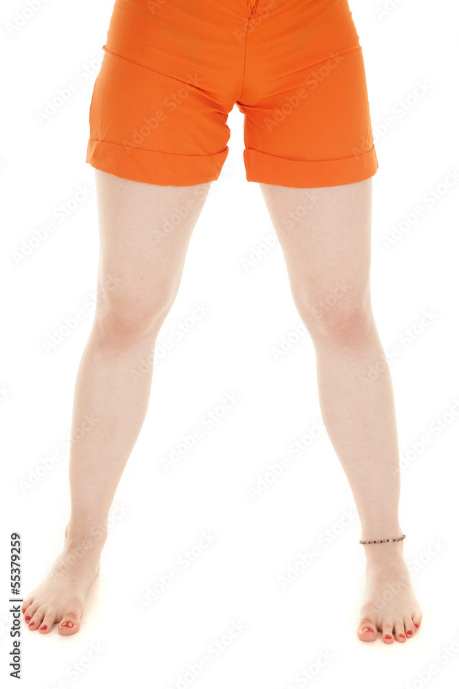 Woman legs orange shorts barefoot