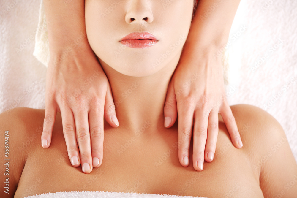 Young relaxed woman enjoy receiving massage