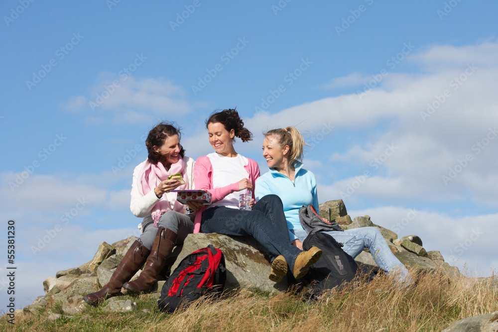Group Of Women Stopping For Lunch On Countryside Walk Group Of Women Stopping For Lunch On Countryside Walk