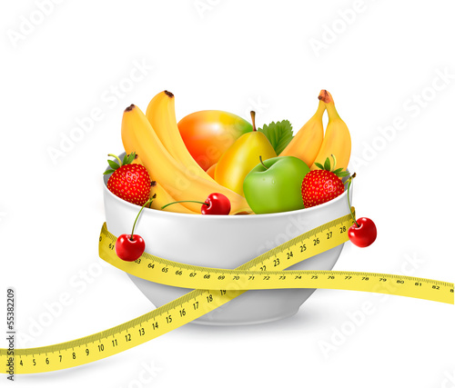 Diet meal. Fruit in a bowl with measuring tape. Concept of diet.
