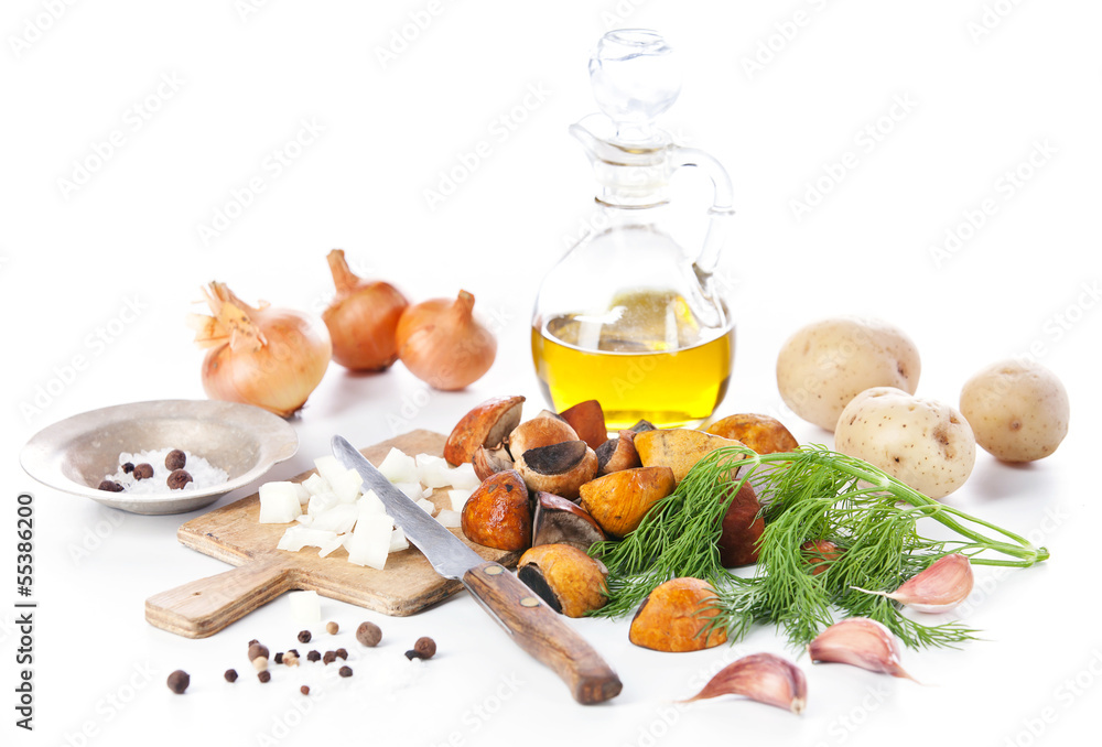 Raw wild mushrooms with oil and spices on white background Raw wild mushrooms with oil and spices on white background